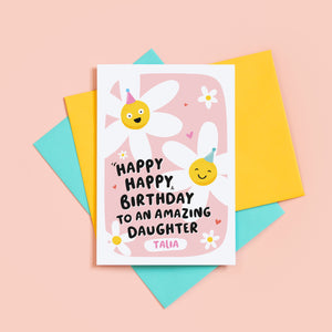 A cute card with a pink background, featuring happy daisies wearing party hats and the words, happy happy birthday to an amazing Daughter. There is space underneath the text to personalise with your Daughter's name.