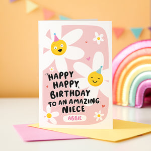 A cute card with a pink background, featuring happy daisies wearing party hats and the words, happy happy birthday to an amazing Niece. There is space underneath the text to personalise with your Niece's name.