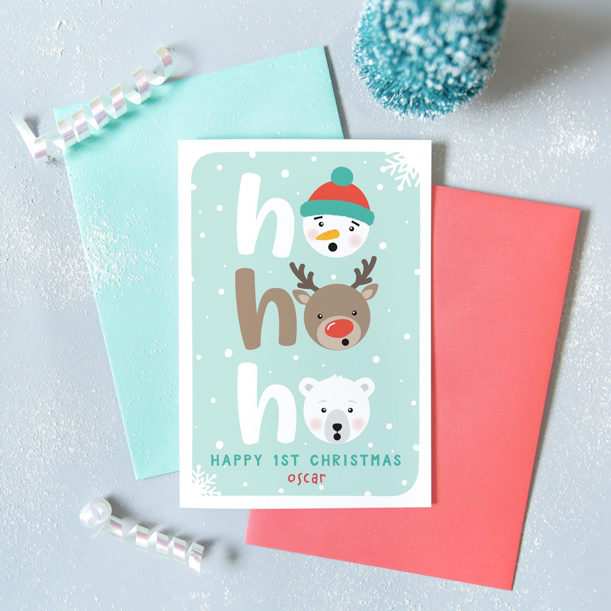 Ho Ho Ho Happy first Christmas. A cute personalised Christmas card with a snowman, reindeer and polar bear. Turquoise background with snowflakes. Add any name and custom message.