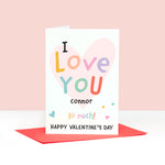 Load image into Gallery viewer, A colourful pastel card with the words I love you happy Valentines day, with space for personalising with a name. The card features a light pink heart in the background overlayed by soft multicoloured text.
