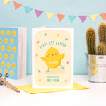 Load image into Gallery viewer, A super cute 1st Easter card featuring a little Easter Chick, mini eggs and spring daisies. The card can be personalised for any recipient and can include baby&#39;s name.
