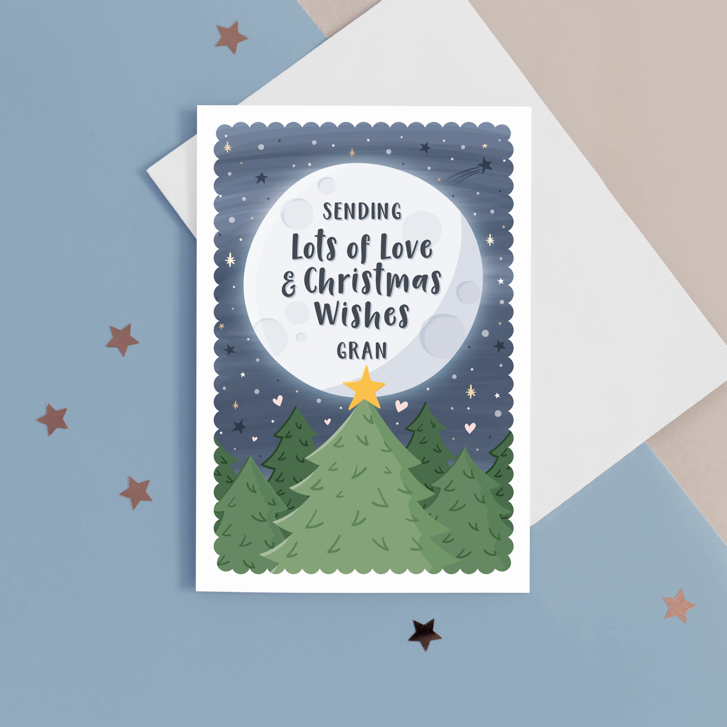 This beautiful Christmas card features festive trees with a star in front of a glowing distant moon which has the personalised message on. This card reads ‘sending lots of love and Christmas wishes Gran', the name for Grandma can be personalised.