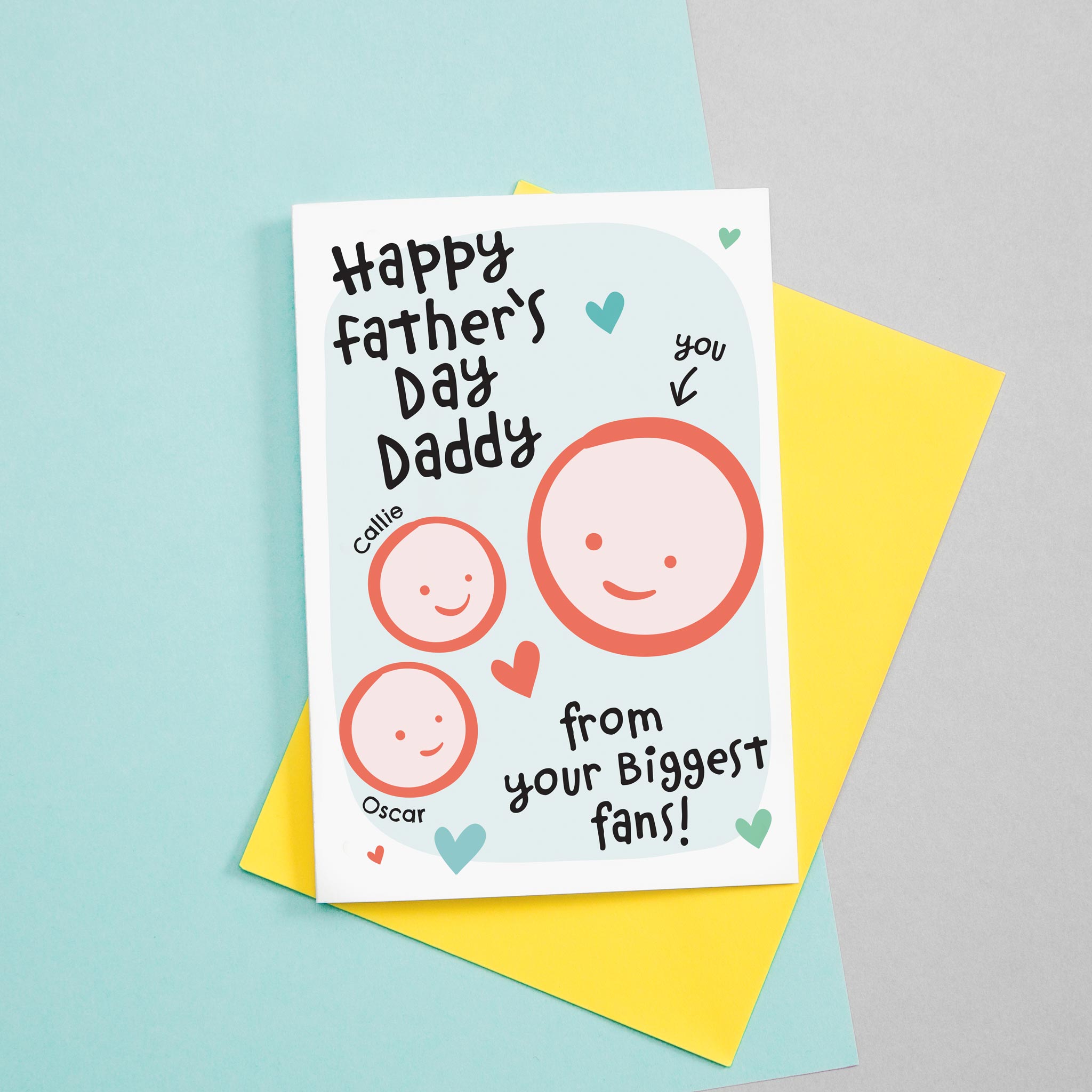 Happy first Father's day - from your biggest fans. This sweet Father's day card features smiling father and two childrens faces with hearts against a turquoise background. Each child's name can be added.