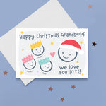 Load image into Gallery viewer, Happy Christmas Grandpops, we love you lots. Cute Christmas card featuring 4 faces representing Grandfather and 3 grandchildren. The smaller faces wear Christmas party hats and the larger face a santa hat. The card is personalised with the children&#39;s names and has a soft grey background.
