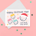 Load image into Gallery viewer, Happy Christmas Yaya, we love you lots. Cute Christmas card featuring 4 faces representing Grandmother and 3 grandchildren. The smaller faces wear Christmas party hats and the larger face a santa hat. The card is personalised with the children&#39;s names and has a soft pink background.
