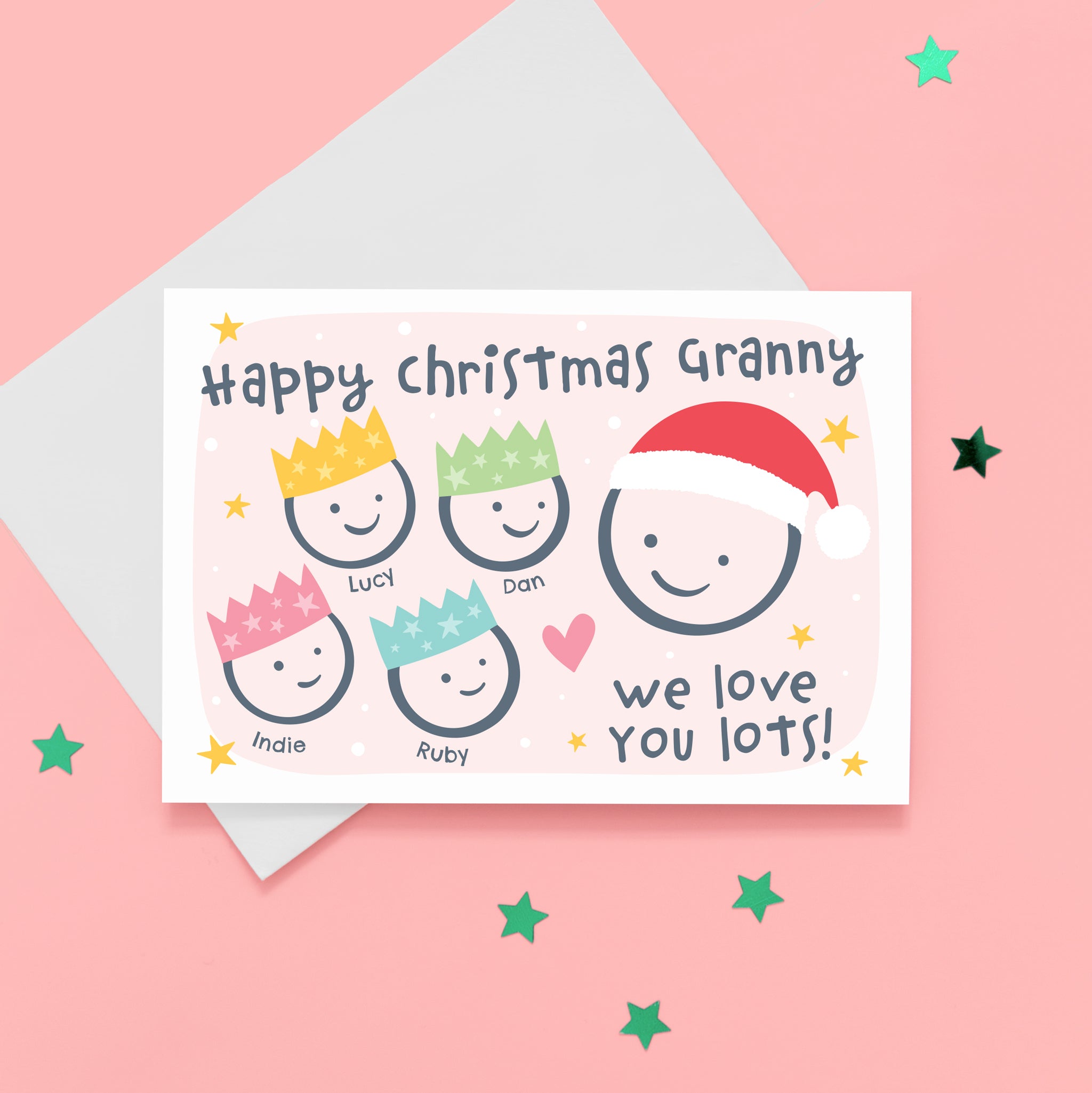 Happy Christmas Granny, we love you lots. Cute Christmas card featuring 5 faces representing Grandmother and 4 grandchildren. The smaller faces wear Christmas party hats and the larger face a santa hat. The card is personalised with the children's names and has a soft pink background.