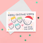 Load image into Gallery viewer, Happy Christmas Granny, we love you lots. Cute Christmas card featuring 5 faces representing Grandmother and 4 grandchildren. The smaller faces wear Christmas party hats and the larger face a santa hat. The card is personalised with the children&#39;s names and has a soft pink background.
