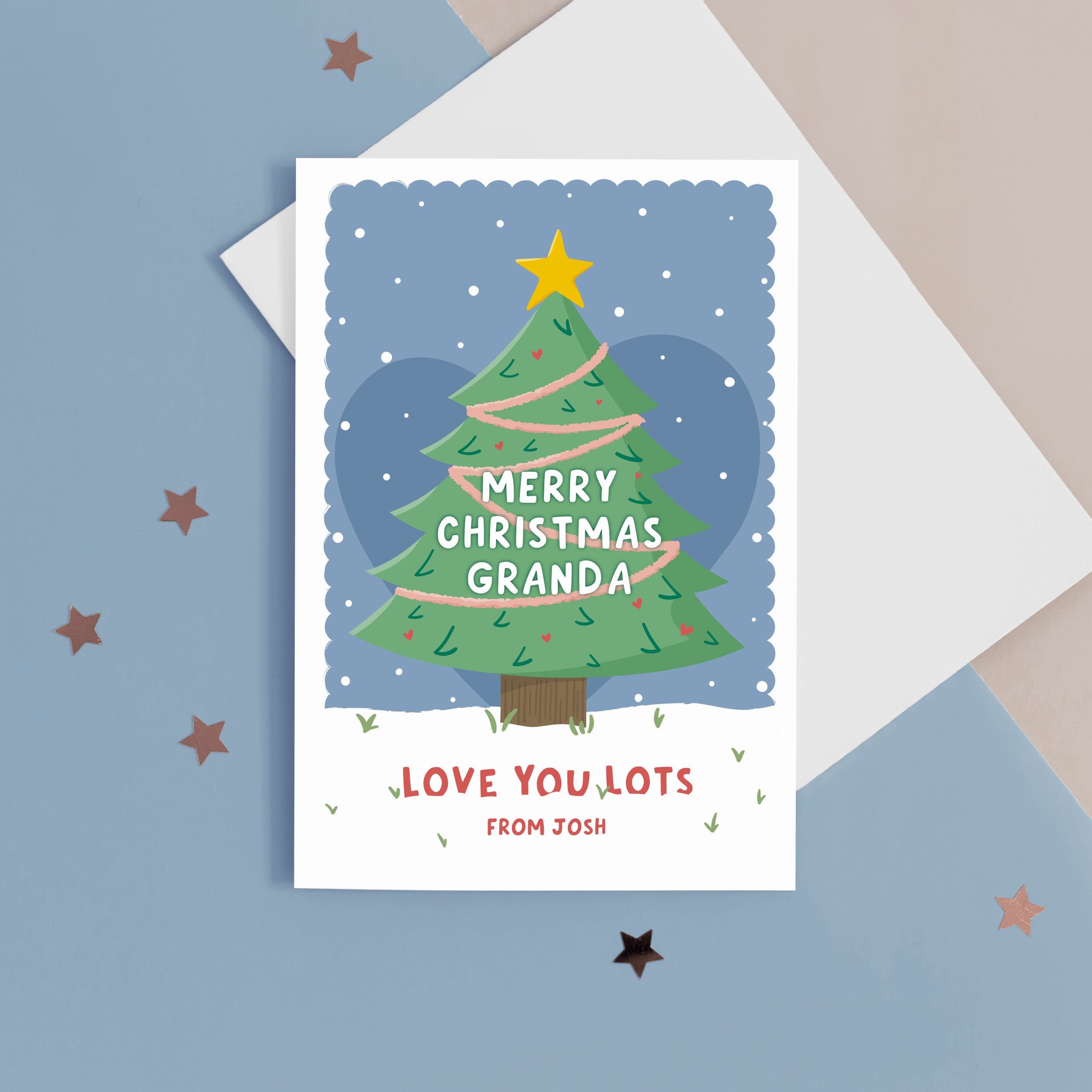 Merry Christmas Grandad. Love you lots. A beautiful Christmas card with a festive tree, star and love hearts on a snowy background in blue. The card can be name customised for Grandad and can include the grandchild’s name(s) at the bottom.