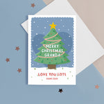 Load image into Gallery viewer, Merry Christmas Grandad. Love you lots. A beautiful Christmas card with a festive tree, star and love hearts on a snowy background in blue. The card can be name customised for Grandad and can include the grandchild’s name(s) at the bottom.
