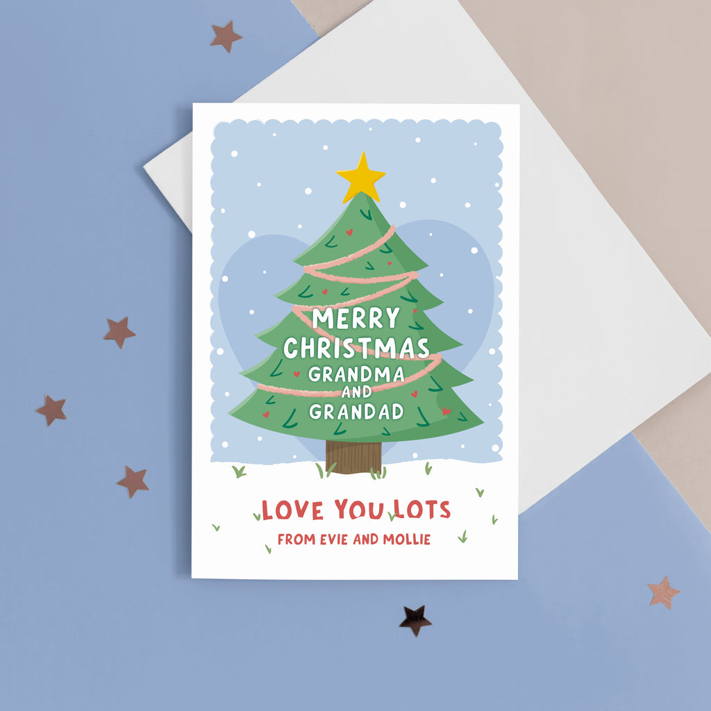 Merry Christmas Grandma & Grandad. Love you lots. A beautiful Christmas card with a festive tree, star and love hearts on a snowy background in blue. The card can be name customised for the grandparents and can include who the card is from at the bottom.