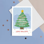 Load image into Gallery viewer, Merry Christmas Grandma &amp; Grandad. Love you lots. A beautiful Christmas card with a festive tree, star and love hearts on a snowy background in blue. The card can be name customised for the grandparents and can include who the card is from at the bottom.
