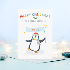 A cute and colourful Christmas card featuring a penguin holding a banner which can be personalised with a child’s name. The card reads Merry Christmas to a Special Grandson – the card can be customised for any recipient.