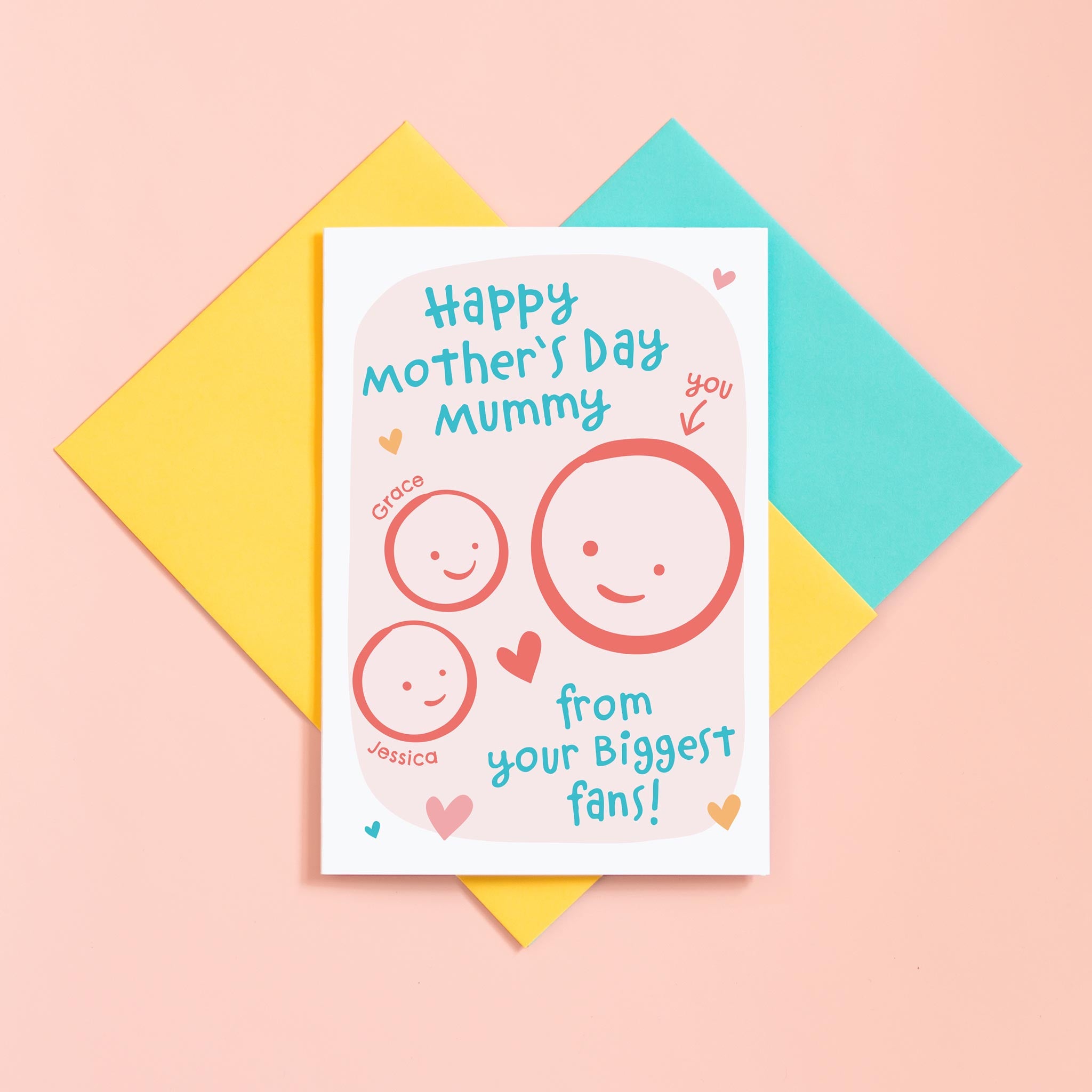 A cute Mother's day card for Mummy from her biggest fans. This card features a smiling face representing Mummy and 2 children's faces which can be personalised with their names. The background of the card is light pink and includes a collection of hearts around the design.