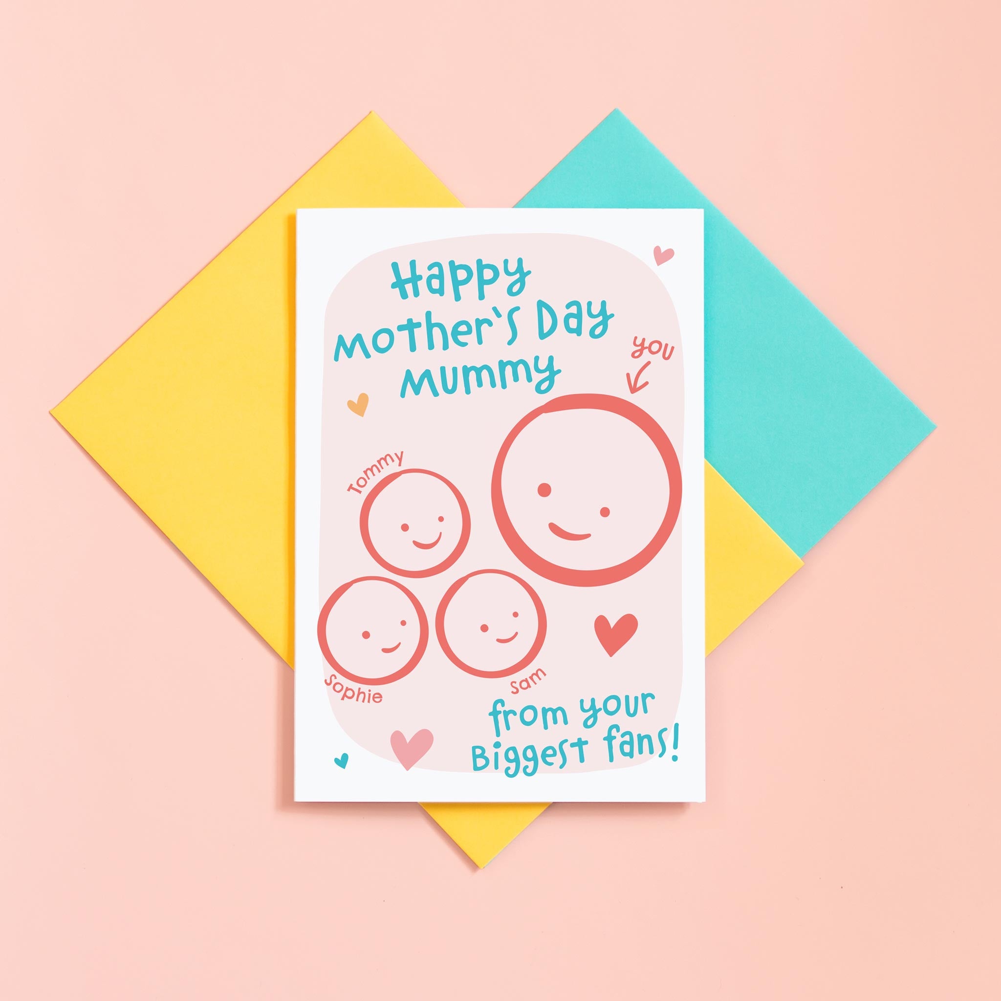 A cute Mother's day card for Mummy from her biggest fans. This card features a smiling face representing Mummy and 3 children's faces which can be personalised with their names. The background of the card is light pink and includes a collection of hearts around the design.