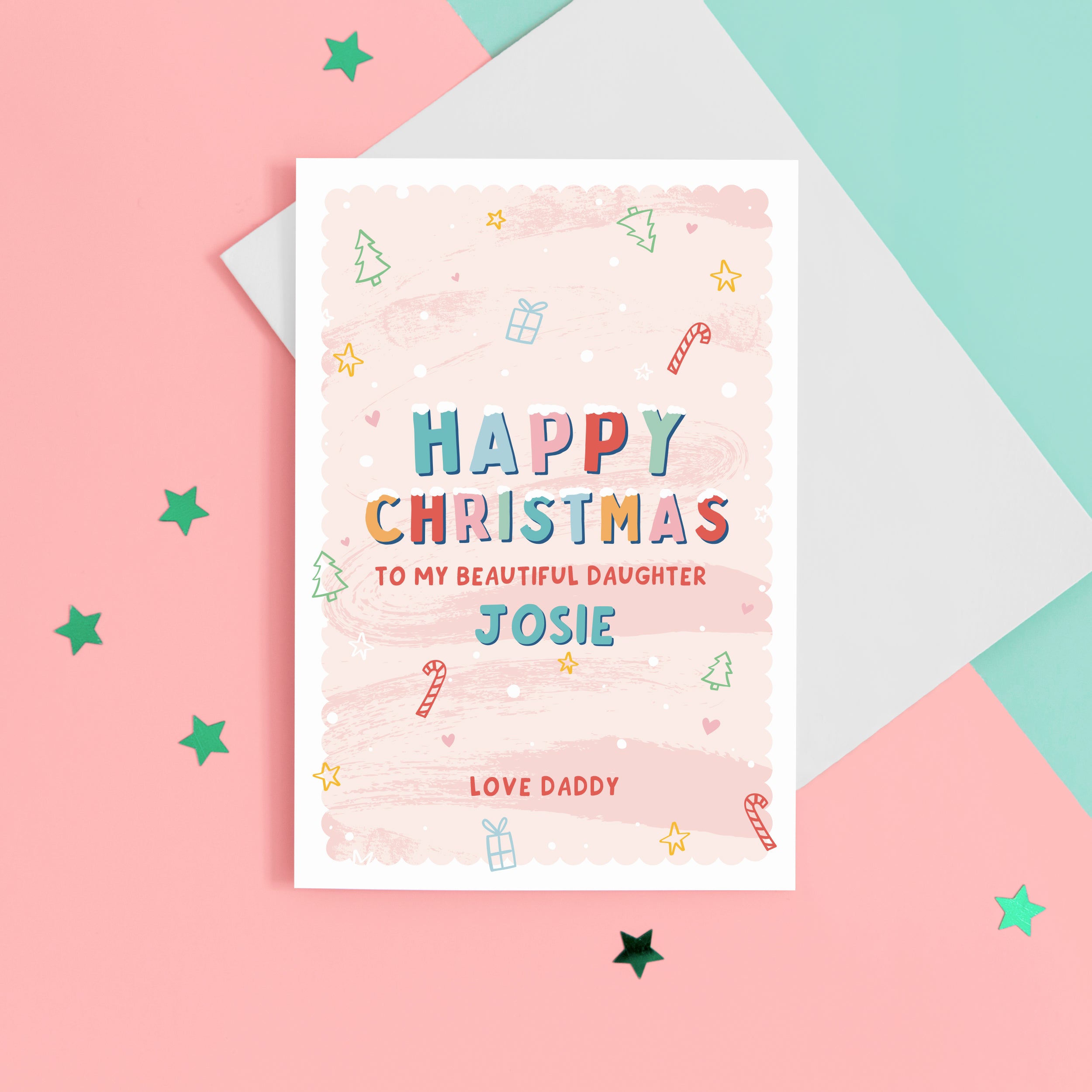 A sweet Christmas card with a pink background and small hand drawn illustrations of Christmas trees, presents, stars and hearts. The card details colourful snow topped wording reading ‘Happy Christmas to my beautiful Daughter’ with space to personalise with your Daughter’s name. The bottom of the card can be customised with your own message such as love Daddy.