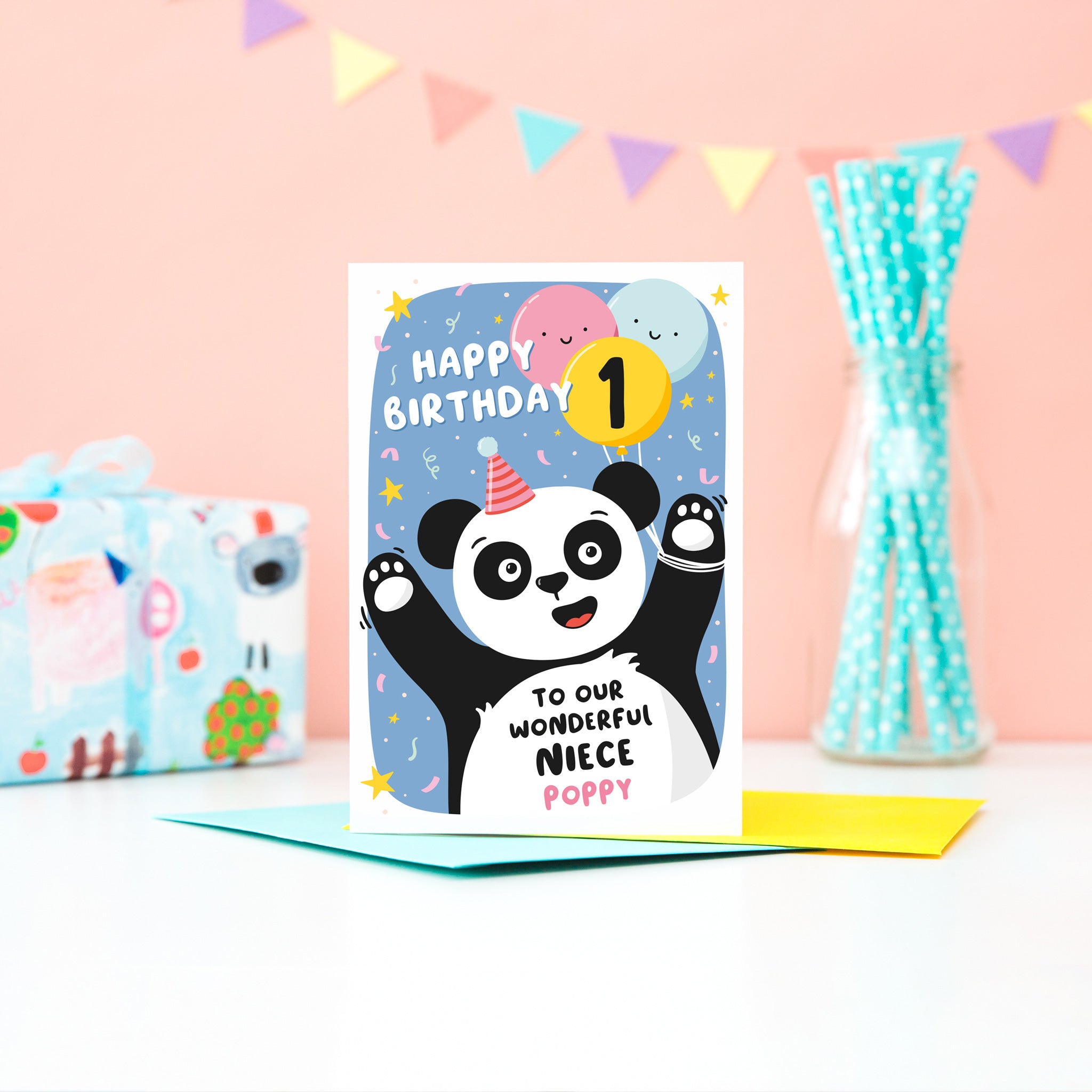 A fun and colourful card featuring a happy panda wearing a party hat, a collection of smiling balloons and a pop of confetti. The card reads happy birthday to our wonderful niece with space to personalise with a name. There is also space on a balloon to add the childs age.