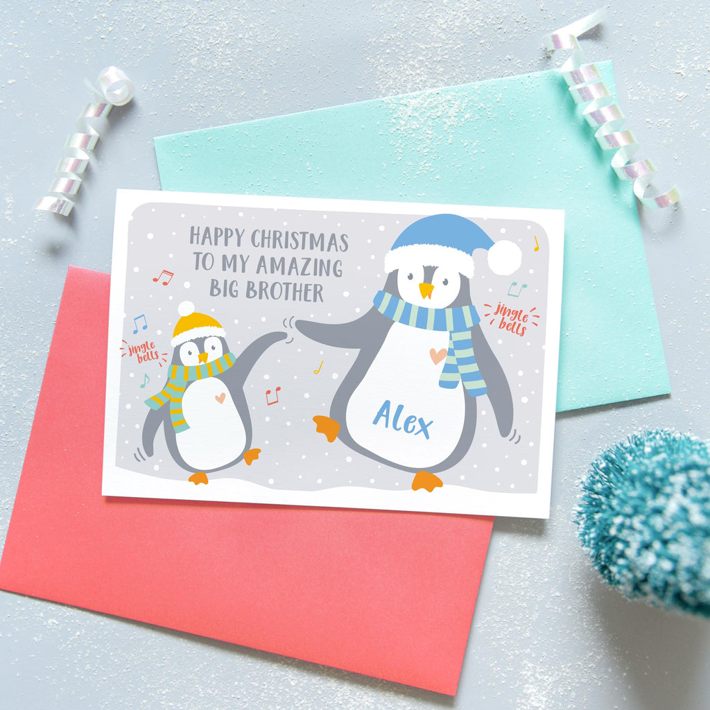 Happy Christmas to my amazing big brother. A cute personalised birthday card featuring a little penguin and a big penguin wearing scarves and hats and dancing. each penguin can be named to represent the sender and recipient