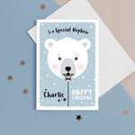 Load image into Gallery viewer, Happy Christmas to a special Nephew. A cute personalised Christmas card featuring a smiling polar bear balloon in snow and stars. Add any name and personal greeting to this card.
