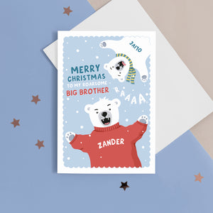 A fun Christmas card featuring two polar bears on a blue snowy background. The card reads ‘Merry Christmas to my roarsome big Brother’. The polar bears can be personalised with names to represent siblings. 