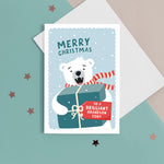 Load image into Gallery viewer, A fun Christmas card featuring a polar bear holding a big present with a tag for personalisation. T The card reads ‘Merry Christmas to a Brilliant Grandson’. The card can be personalised for any recipient .
