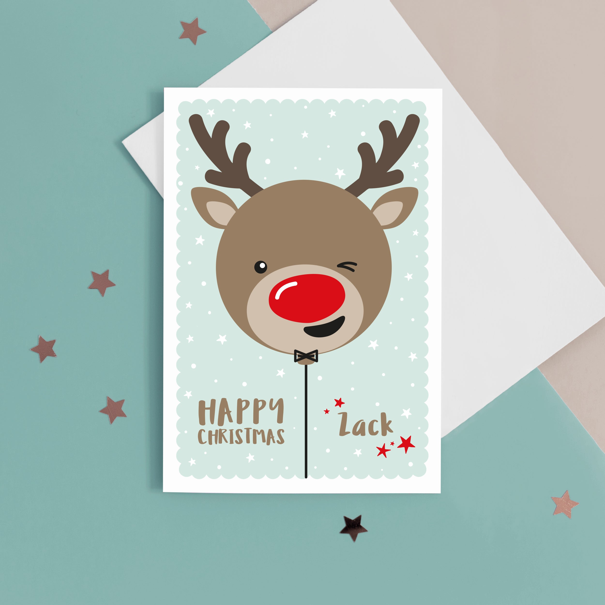 Happy Christmas. A cute personalised christmas card featuring a cheeky red nosed reindeer in snow and stars. Add any name to this Christmas card.