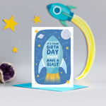 Load image into Gallery viewer, A bright and colourful birthday card featuring a rocket and a space scene with the  words, &#39;It&#39;s your birthday have a blast&#39;. There is an option to personalise this card with a name.
