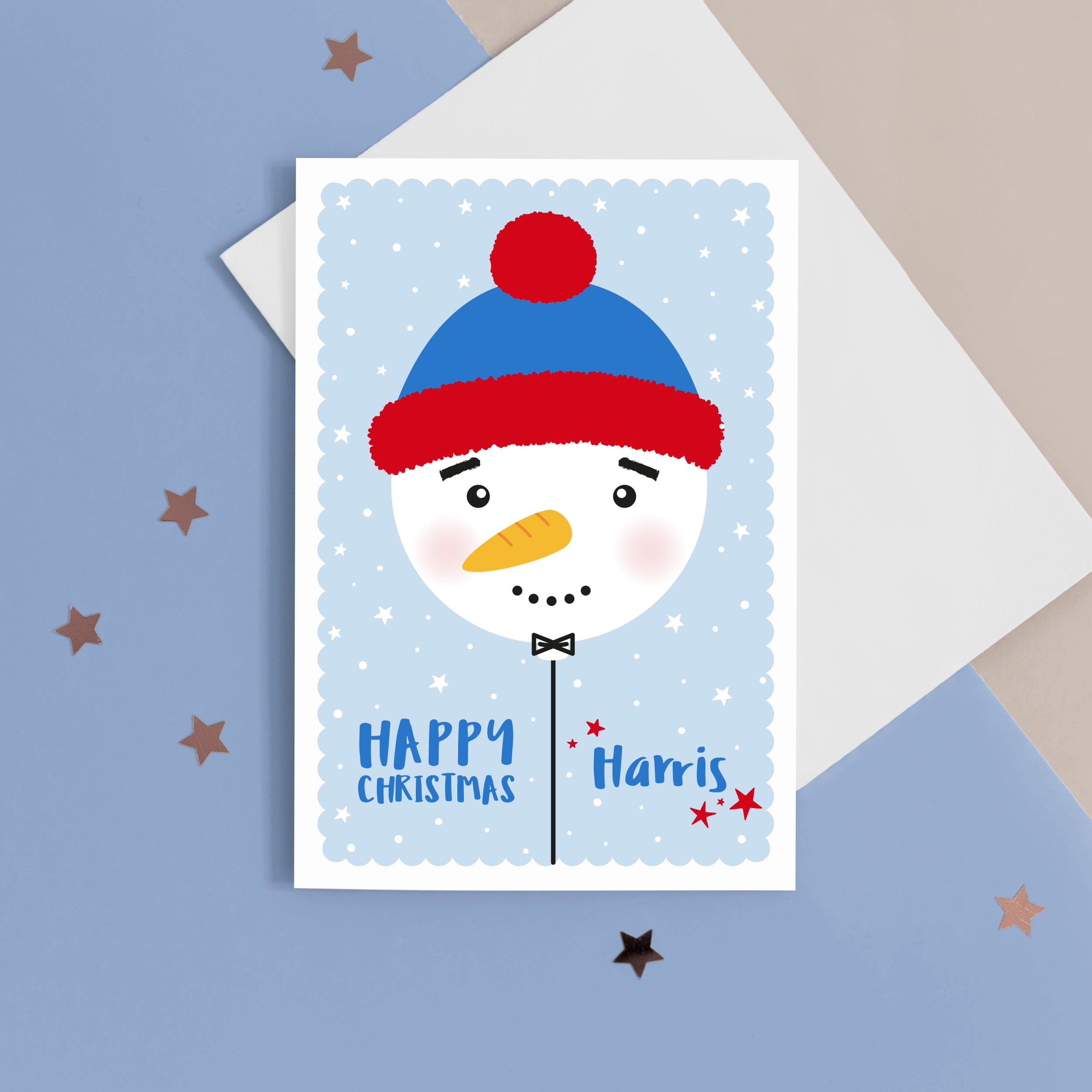 Happy Christmas. A cute personalised christmas card featuring a cute snowman on blue background with snow and stars. Add any name to this Christmas card.