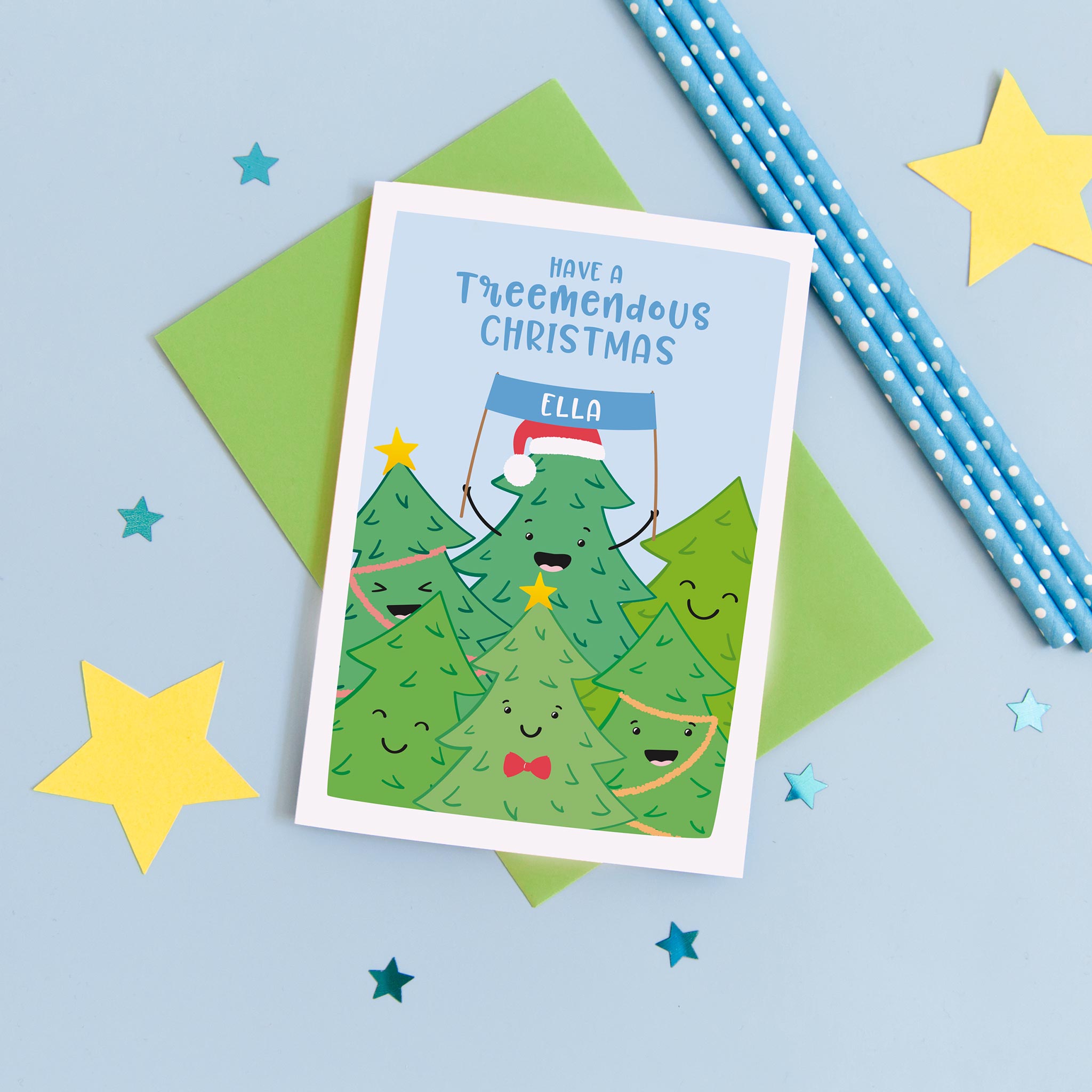 A fun and colourful card featuring a collection of happy smiling Christmas trees and the words 'have a treemendous Christmas'. The card can be personalised with the recipients name.