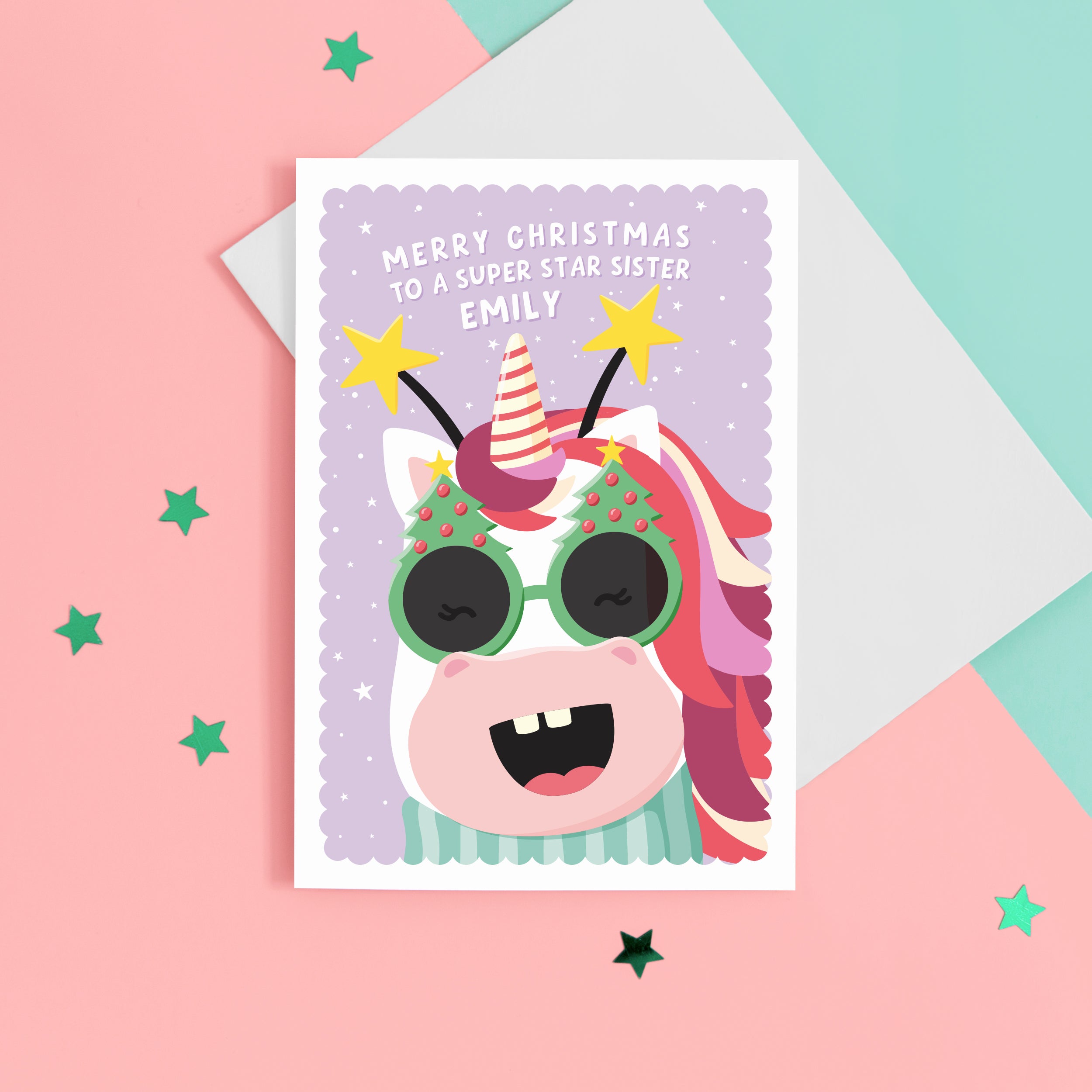 A fun and colourful Christmas card featuring a happy unicorn face, wearing festive Christmas glasses and a star headband. The card reads ‘Merry Christmas to a super star Sister’ but can be personalised for any recipient and has space to add the recipients name.