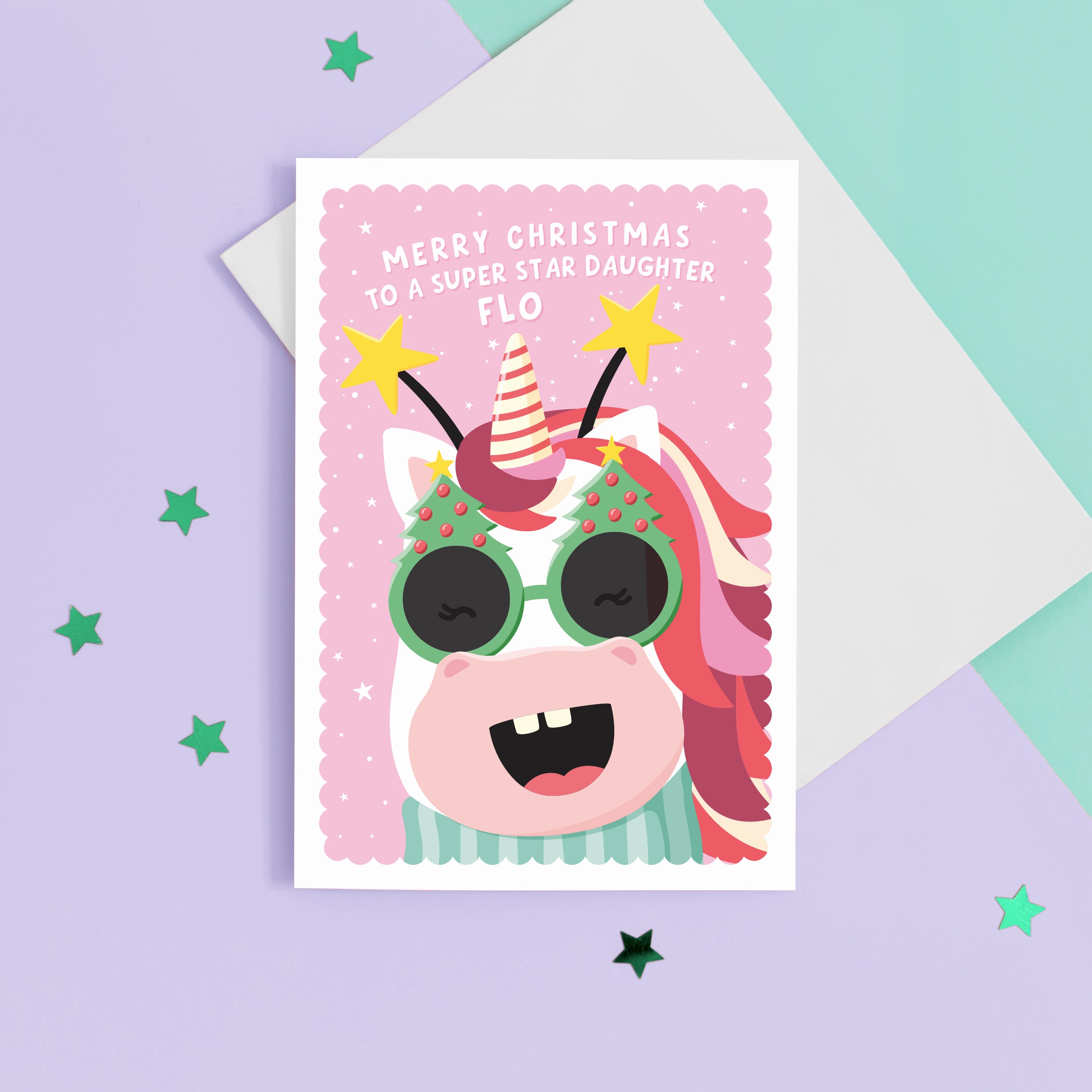 A fun and colourful Christmas card featuring a happy unicorn face, wearing festive Christmas glasses and a star headband. The card reads ‘Merry Christmas to a super star Daughter’ but can be personalised for any recipient and has space to add the recipients name.