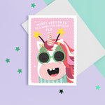 Load image into Gallery viewer, A fun and colourful Christmas card featuring a happy unicorn face, wearing festive Christmas glasses and a star headband. The card reads ‘Merry Christmas to a super star Daughter’ but can be personalised for any recipient and has space to add the recipients name.
