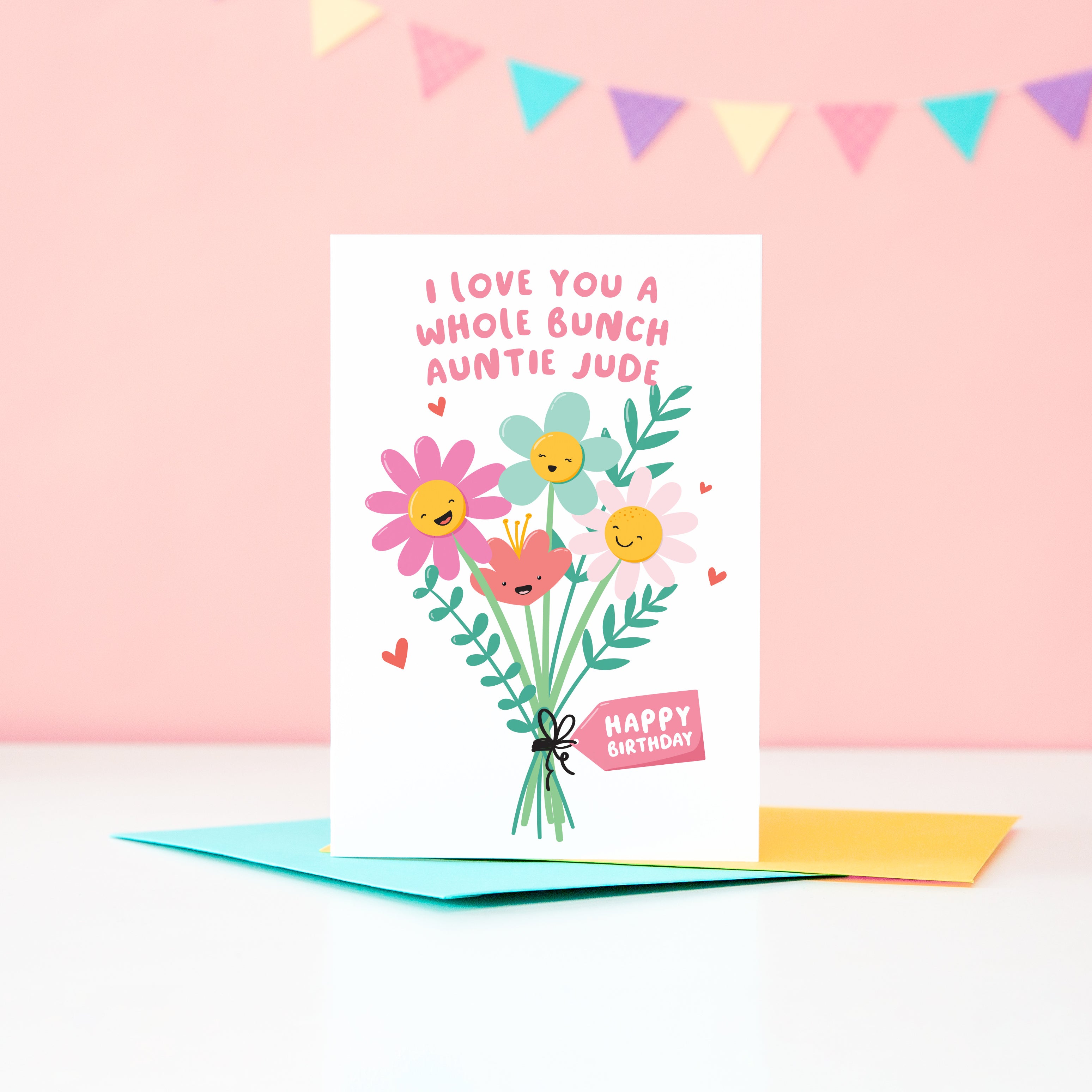 A super cute birthday card for an Auntie, featuring a bunch of happy smiling flowers and a collection of small hearts. The card reads, ‘I love you a whole bunch’ with space to personalise with Auntie’s name. 