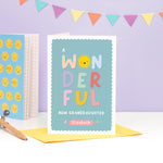 Load image into Gallery viewer, A colourful card featuring the words &#39;a wonderful baby Granddaughter’ with space to personalise with a name. The card has a turquoise background and the word &#39;wonderful&#39; has bright colours with a smiley sunshine face for the letter &#39;o&#39;.
