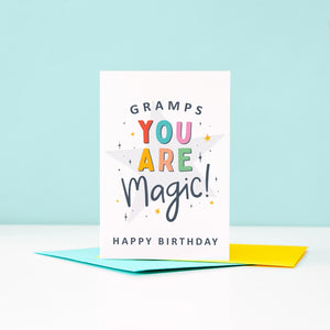 Gramps you are magic Happy Birthday. This bright and colourful typographic card features stars and bold text.