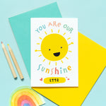 Load image into Gallery viewer, You are our sunshine card with personalised name. This cute and colourful card features a smiling happy sun and any personalised name.
